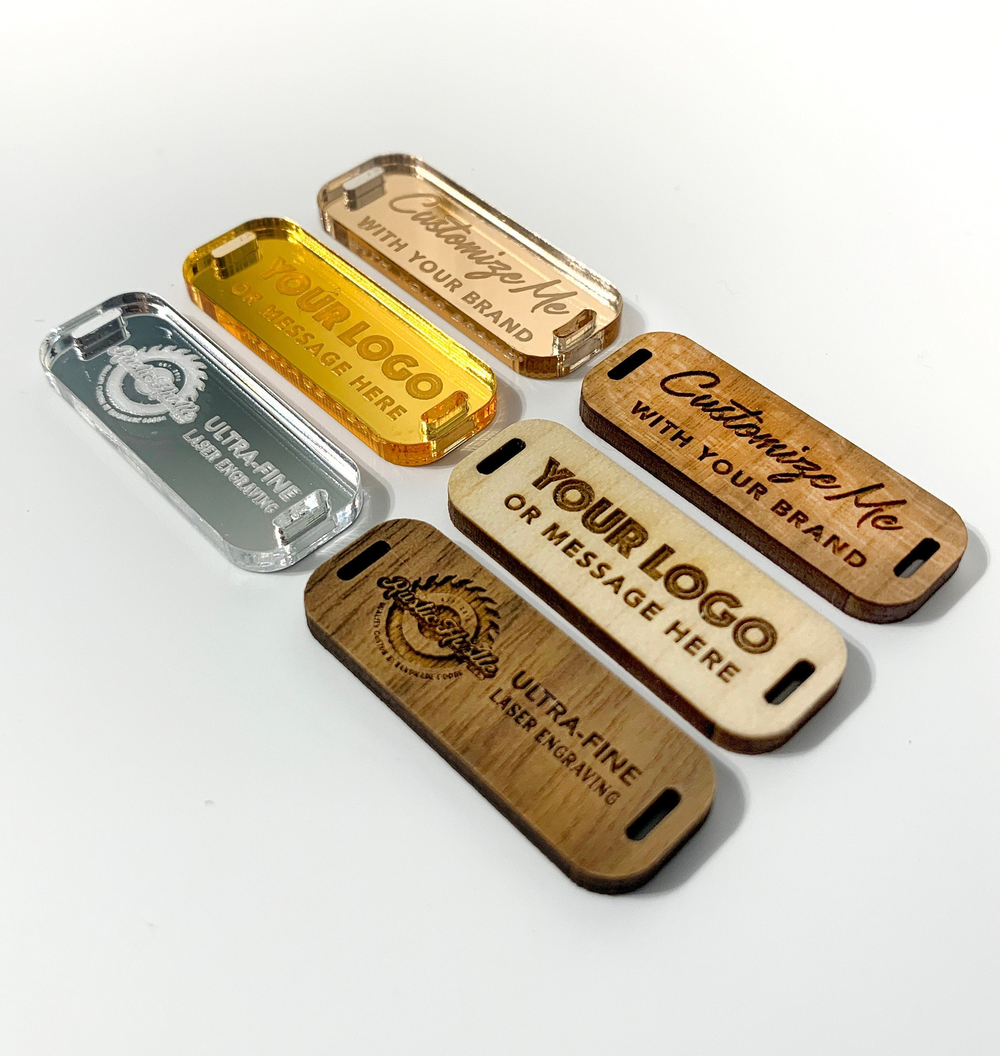 six custom-made labels, each with a unique design and inscription, arranged in a row.