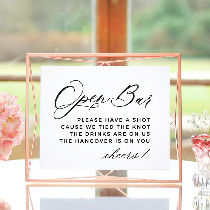a sign that reads "Open Bar" with a humorous message about the drinks being on the hangover.
