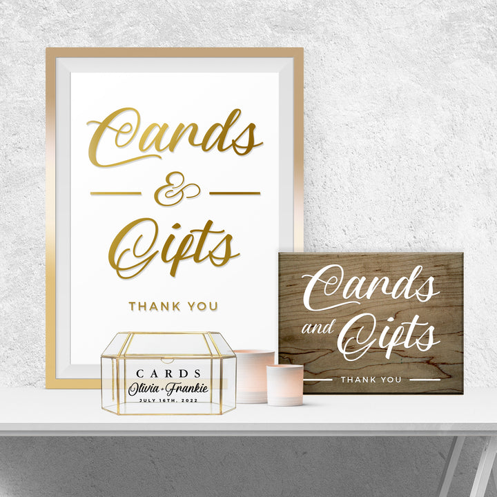 a framed sign that reads "Cards & Gifts Thank You" and a wooden sign that reads "Cards and Gifts Thank You". There is also a small box labeled "Cards & Gifts" on a shelf.
