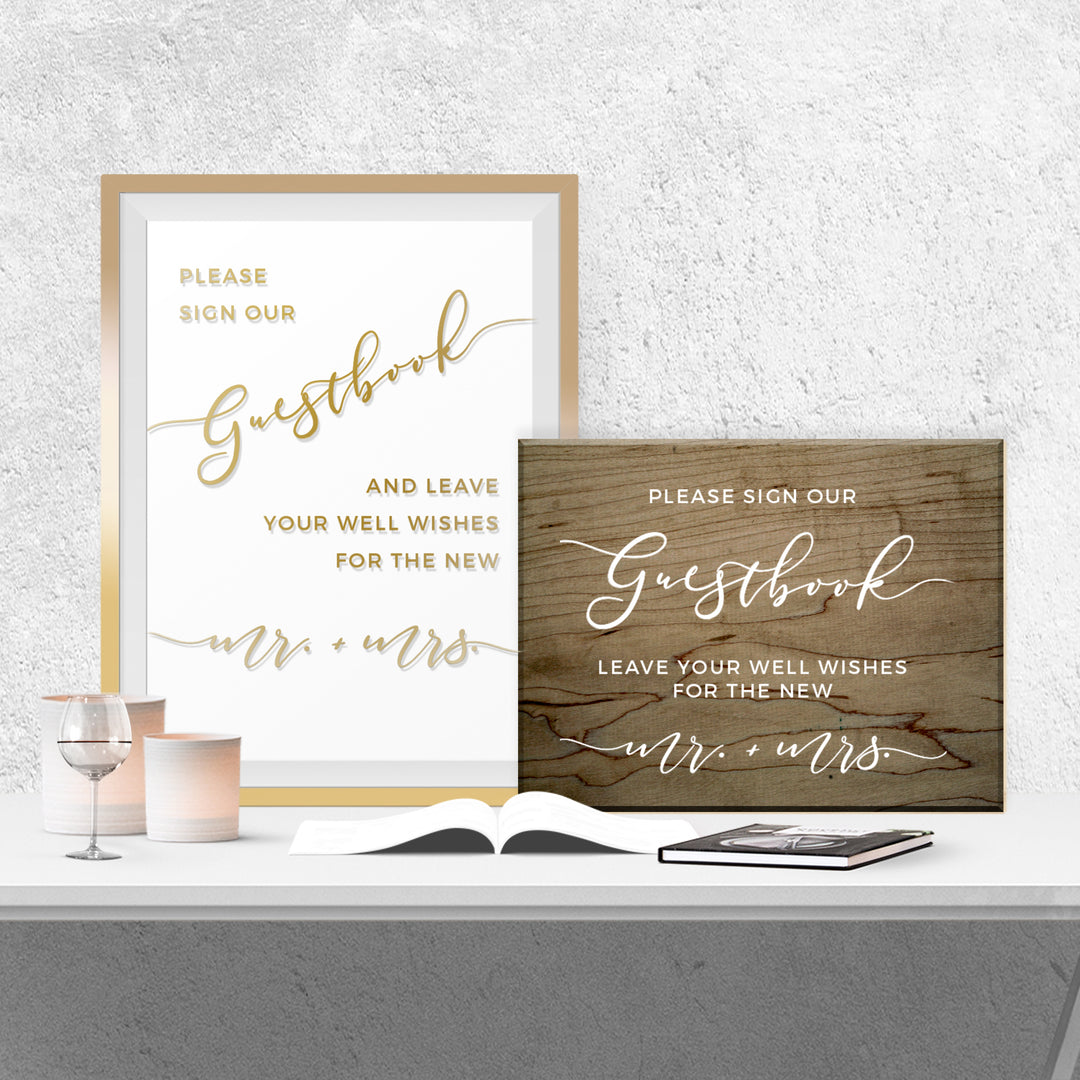 two framed signs on a table, one with a white background and gold lettering, and the other with a wooden background and white lettering.