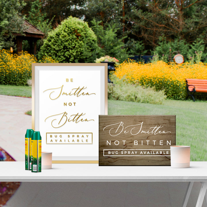 a sign that reads "Be Smitten Not Bitten Bug Spray Available" and a wooden sign that reads "Be Smitten Not Bitten Bug Spray Available".