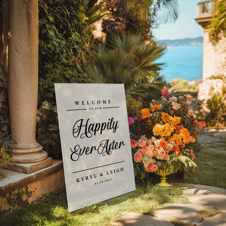 a welcome sign in front of some flowers