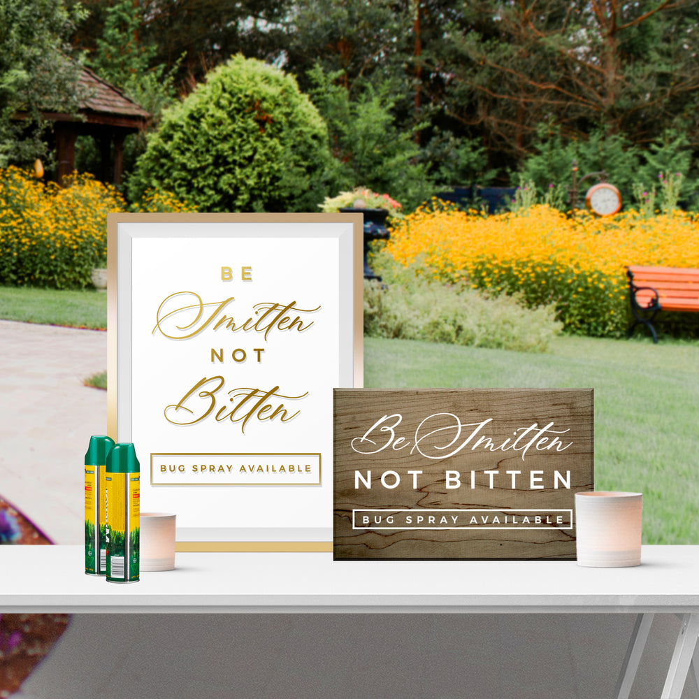 two signs with the same message, placed on a table in a garden setting.