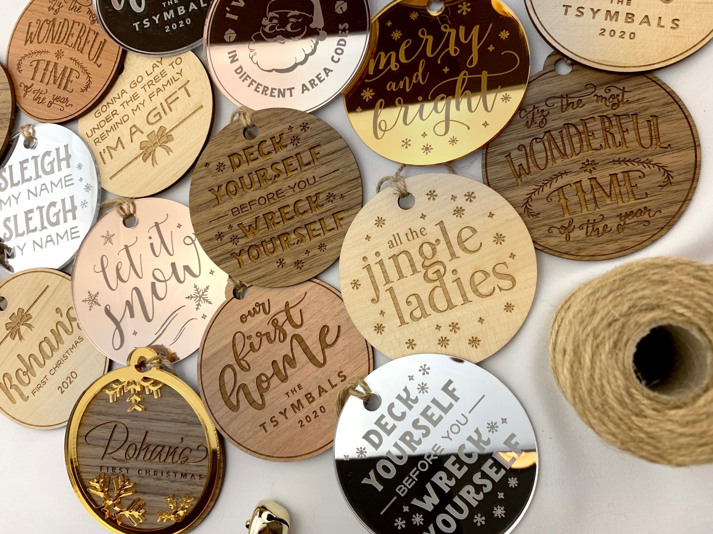 Collection of wooden Christmas tags with various inscriptions on a white background.