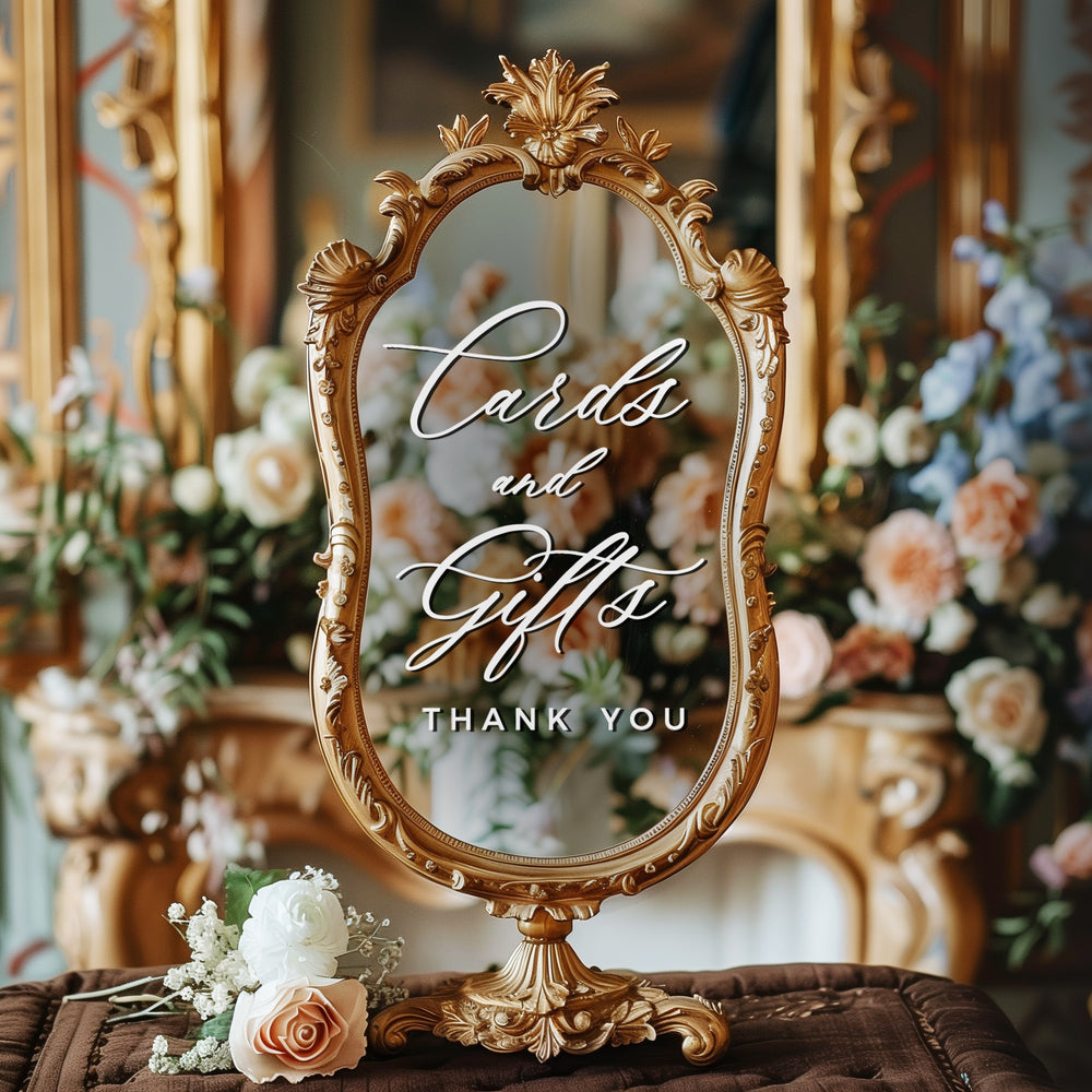 a decorative mirror with a sign that reads "Cards and Gifts Thank You" in an ornate golden frame.