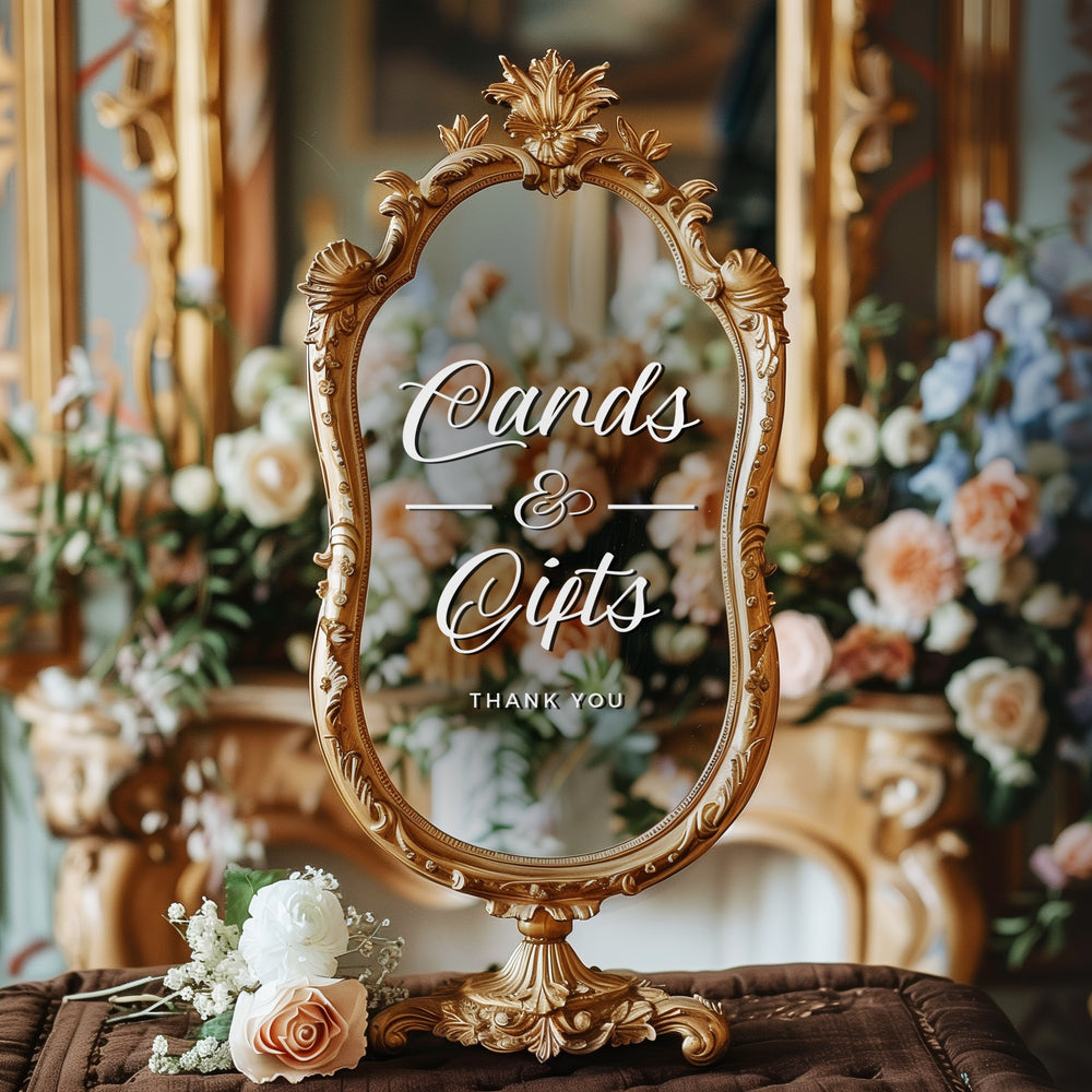 a decorative mirror with a sign that reads "Cards & Gifts" in the center, surrounded by a floral arrangement.