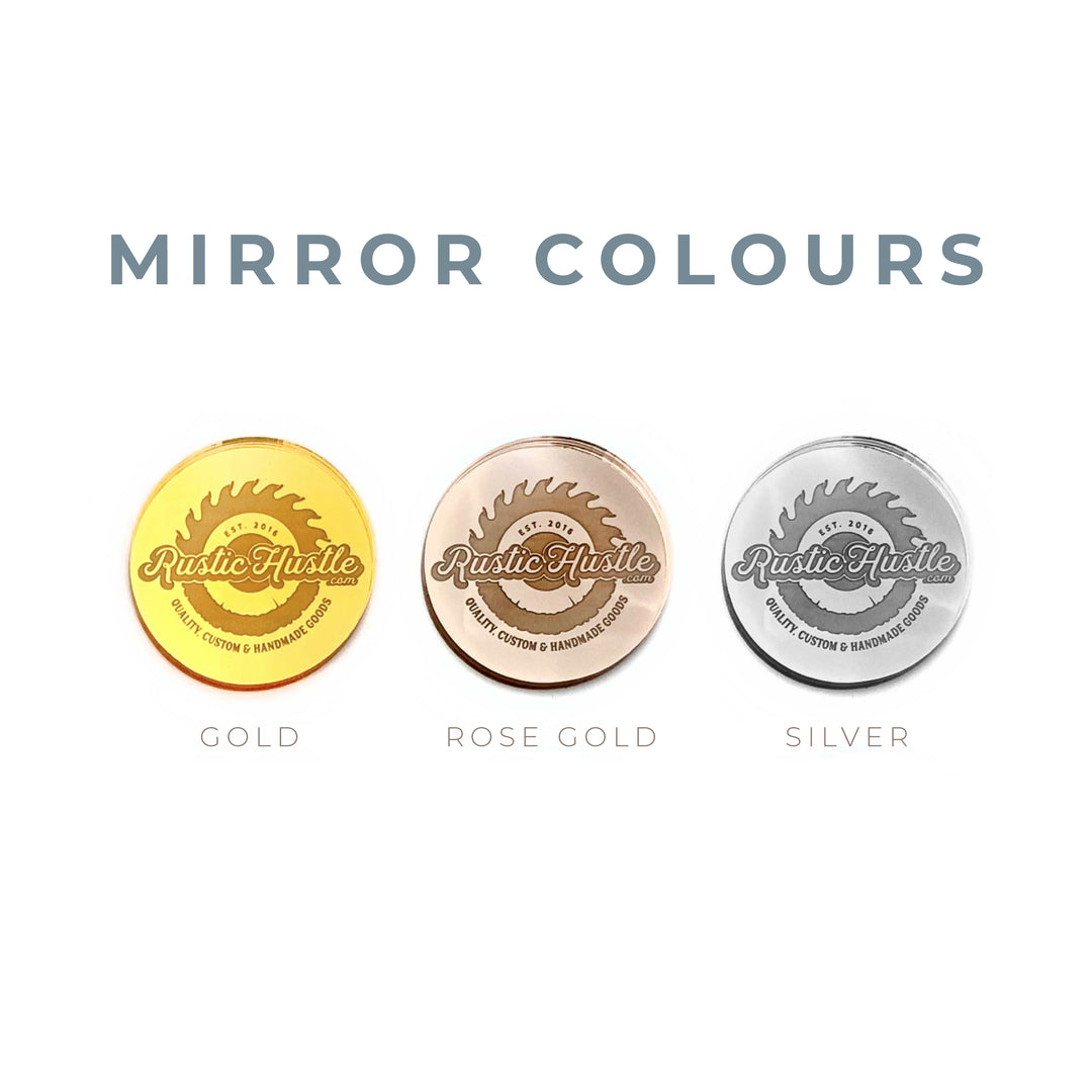 three circular medals with the text "RUSTIC HUSTLE" on them, each representing a different color: gold, rose gold, and silver.