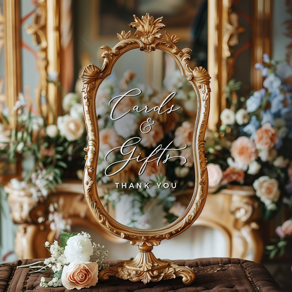 a decorative mirror with a floral arrangement in the background.