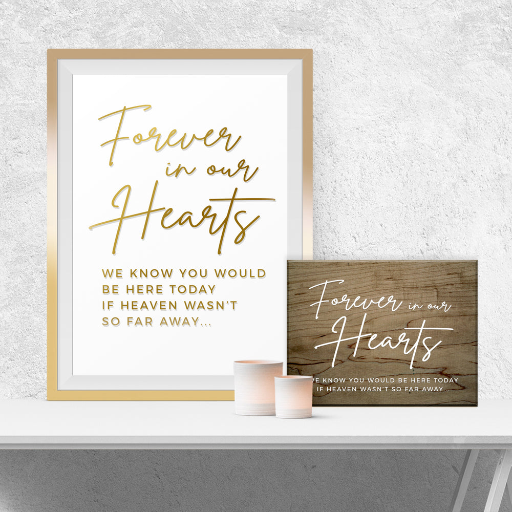 a framed quote that reads "Forever in our hearts" in a gold frame, placed on a white shelf next to a wooden sign with a similar quote.